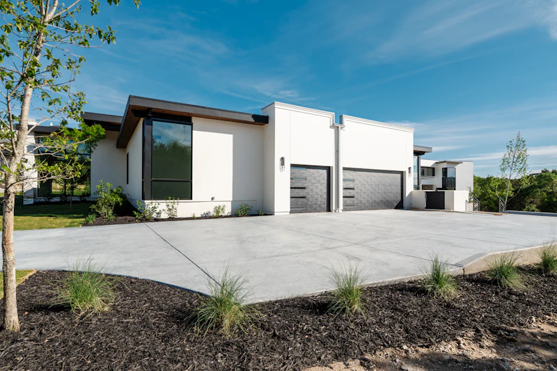 Finished concrete driveway in front of a modern home